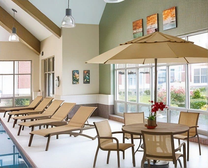 Grosfillex sling chaise lounges in an indoor pool room